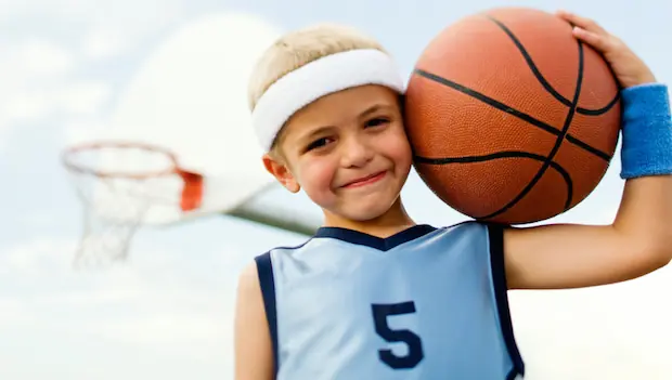 A kid playing basketball.